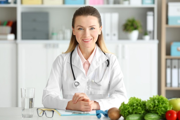 Young female nutritionist in her office