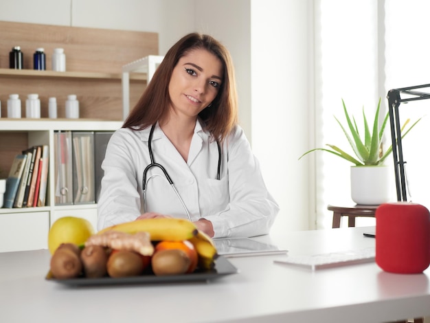 Young female nutritionist in office