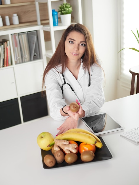 Young female nutritionist in office