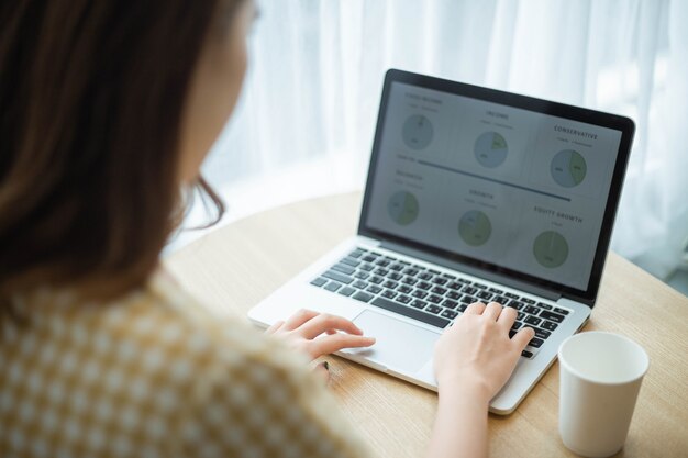 A young female officer summarizing data to create into an infographic for presentation.