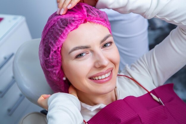 Photo young female patient with pretty smile examining dental inspection at dentist clinic healthy teeth