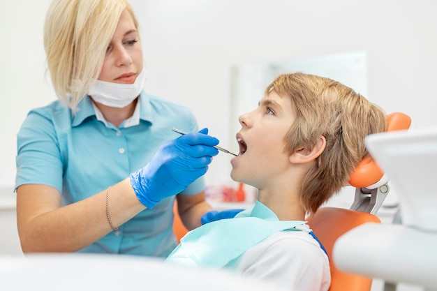 Young female pediatric dentist using a