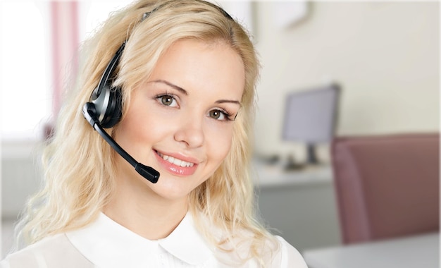 Young female phone service manager on blurred office background