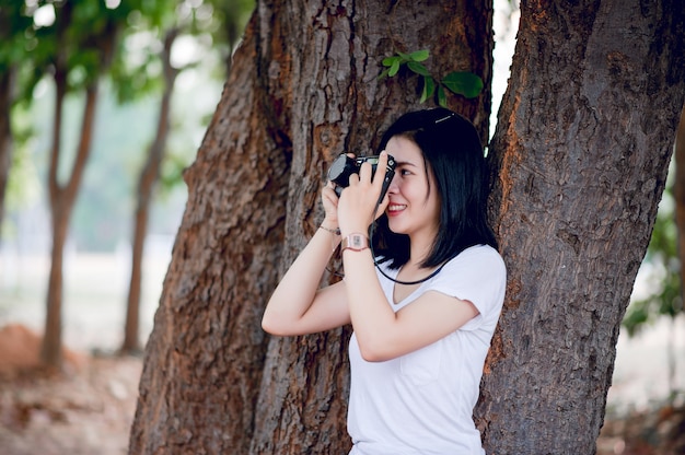 Young female photographer in the park