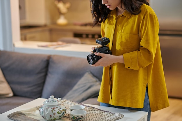 Young female photographer with camera in hands