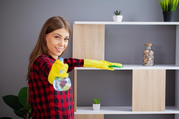 A young female professional cleaner cleans a modern office