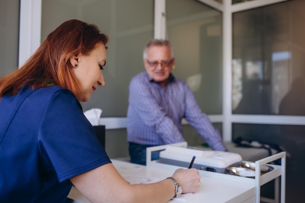 Young female professional doctor physician consulting old male patient talking to senior adult man client at medical checkup visit Geriatric diseases treatment Elderly medical health care concept