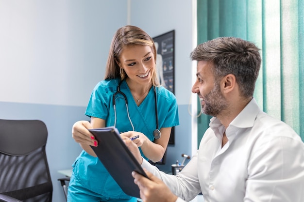 Young female professional doctor physician consulting patient talking to adult man client at medical checkup visit diseases treatment medical health care concept