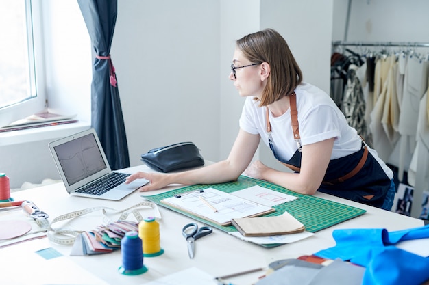 Young female purse maker at work