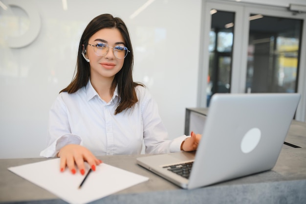 Young female receptionist working in office