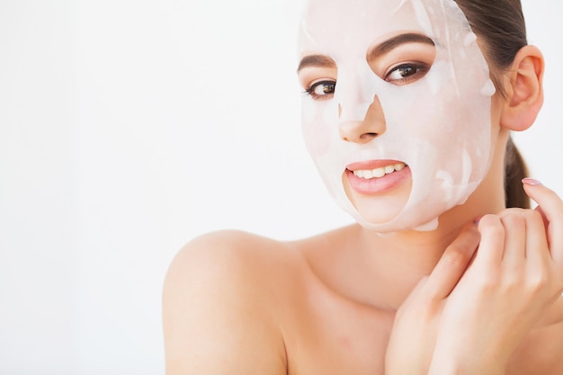 Young Female Removing Mask From Facial Skin