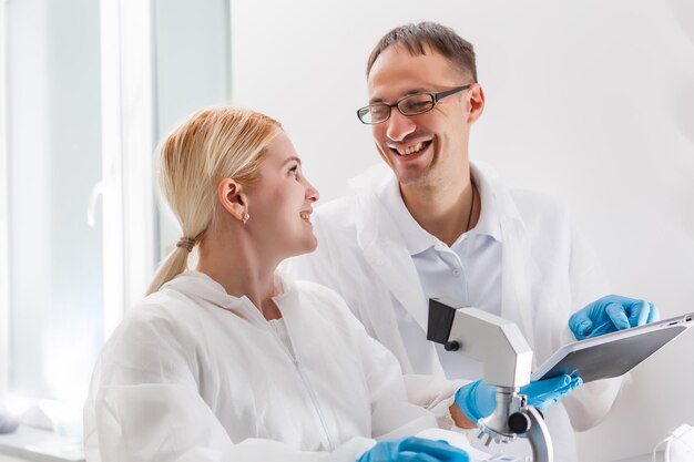 Young Female Scientist Analyzing Sample In Laboratory