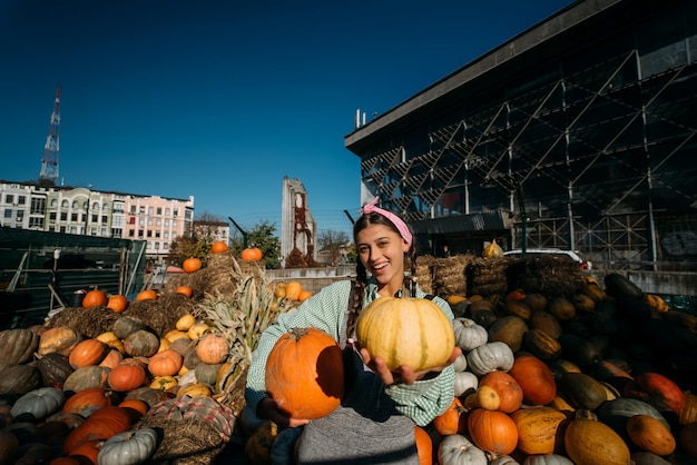 A young female seller is showing the autumn harvest