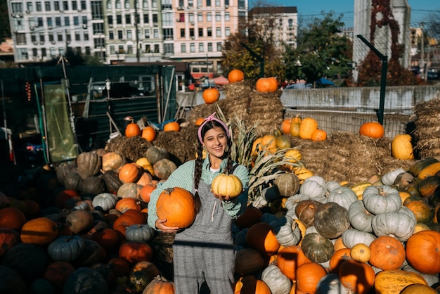 A young female seller is showing the autumn harvest