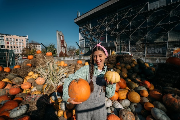 A young female seller is showing the autumn harvest