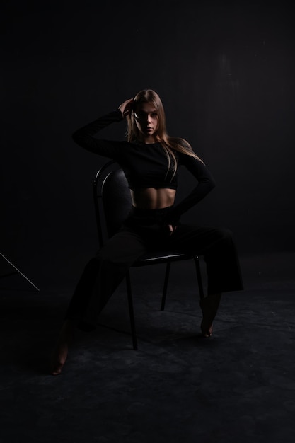 Young female sexy fashion caucasian background black chair beautiful luxury beauty woman girl