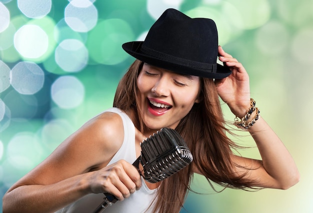 Young female singer with vintage microphone