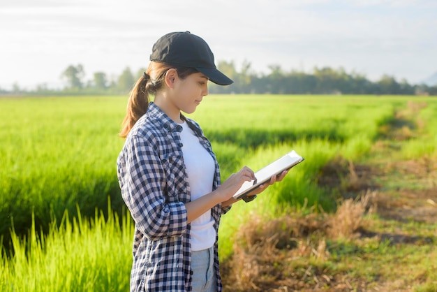 A young female smart farmer with tablet on field,High technology innovations and smart farming