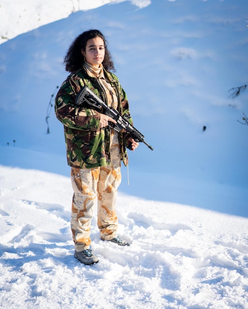 Young female soldier in military uniform on winter snow high quality photo