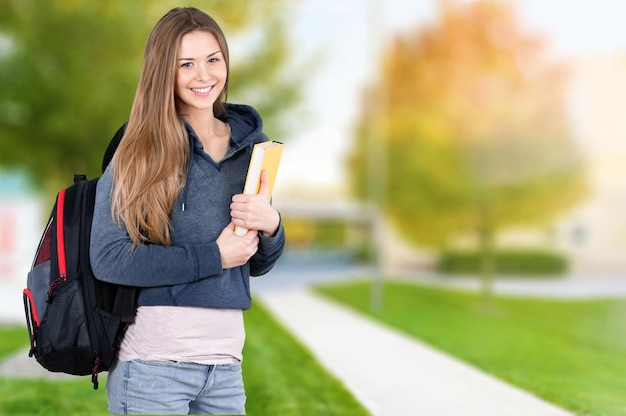 Young female student  on background