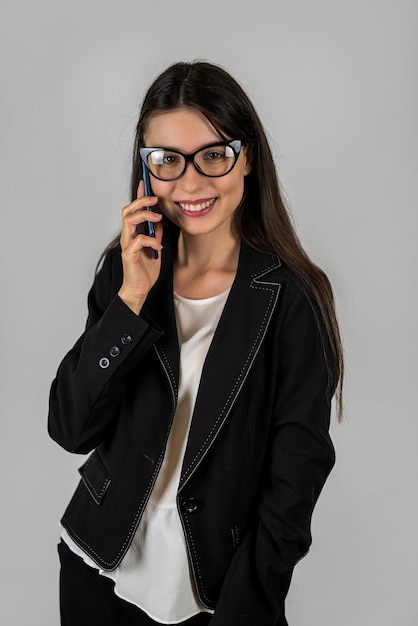 Young female student in business clothes smiling widely in photo isolated on background