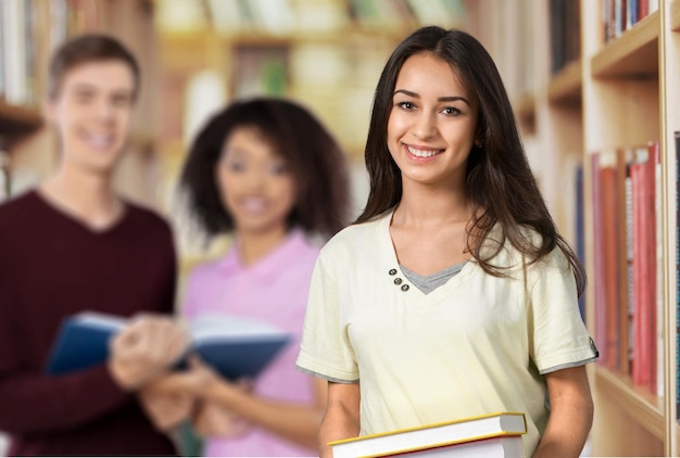 Young female student, her classmates on background