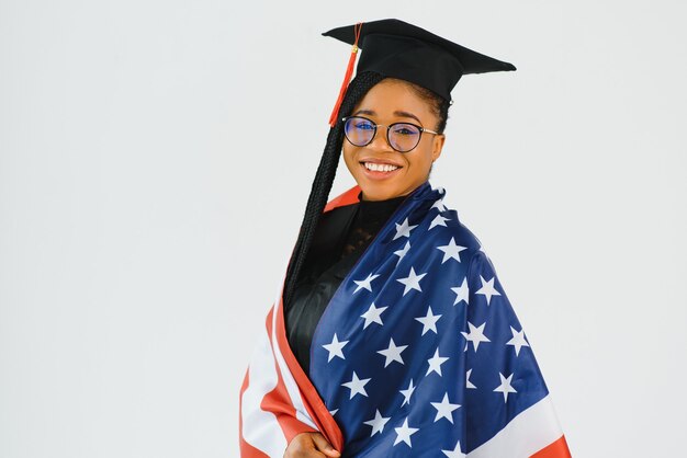 Young female student in robe celebrating her graduation