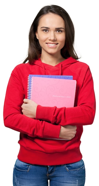 Young female students carrying notebooks