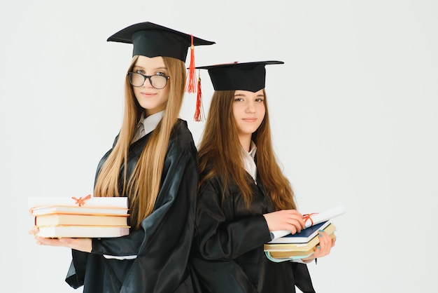 Young female students in robe celebrating their graduation