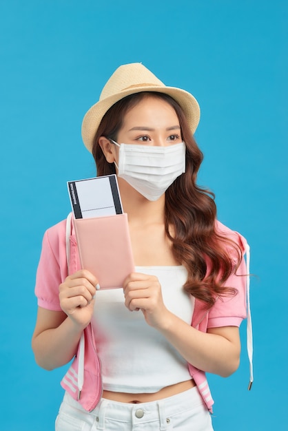 Young female traveller wearing face mask for protection coronavirus