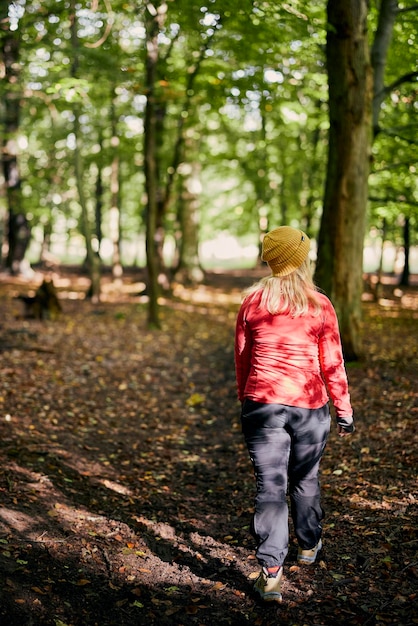 Young female walking in forest