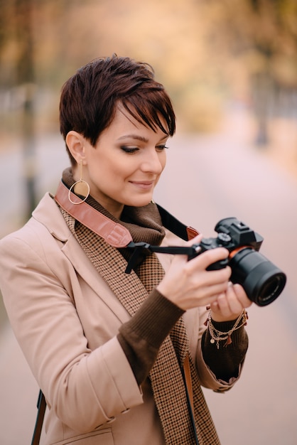 Young female with camera in hand, close up