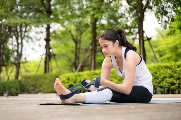 Young female on a wooden bridge in the park with healthy yoga activities