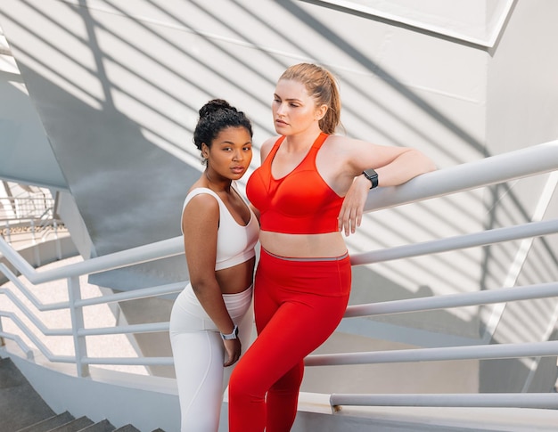 Young females in sportswear with plussize bodies standing together