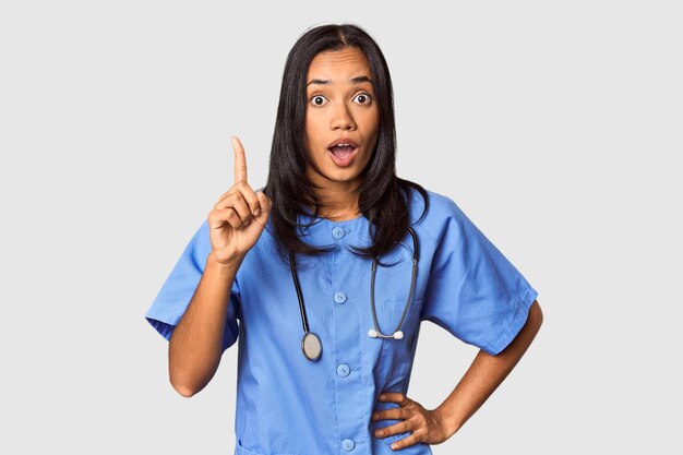 Young Filipina nurse posed in studio having an idea inspiration concept