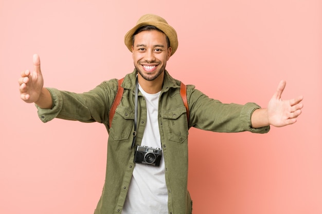 Young filipino traveler man feels confident giving a hug .