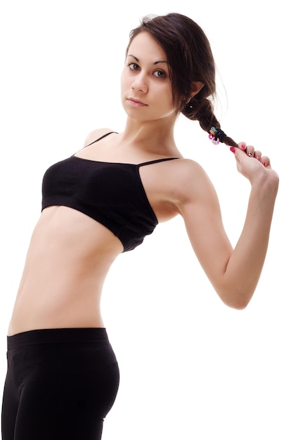 Giovane donna bruna in forma e bella in abbigliamento sportivo isolato su grigio dieta sanitaria sport e concetto di fitness