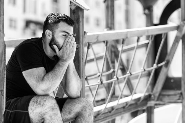 Young Fit Handsome Adult Man Resting Outdoors on Playground Park