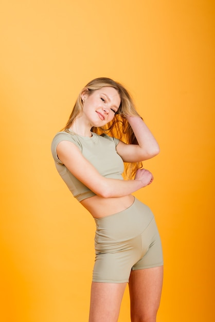 Young fit woman training in sports outfit, studio photo