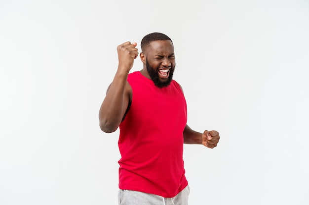 Young fitness african black man in sport wear cheering carefree and excited, Victory concept.