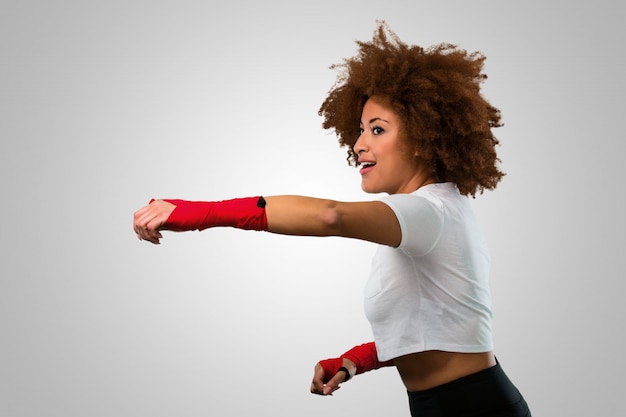 Young fitness afro woman boxing