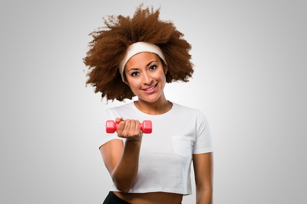 Young fitness afro woman exsercising with dumbbells