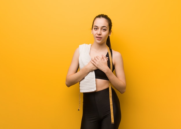 Young fitness girl doing a romantic gesture