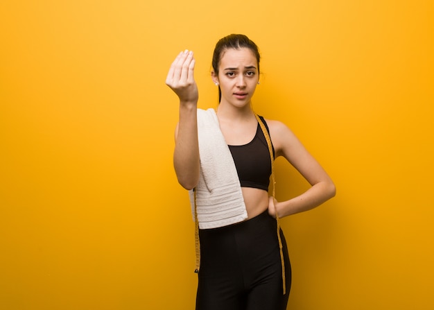 Young fitness girl doing a typical italian gesture