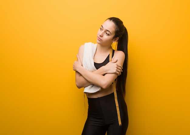 Young fitness girl giving a hug