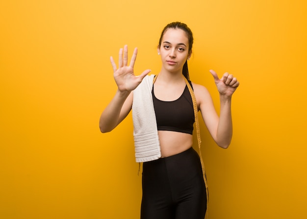 Young fitness girl showing number six