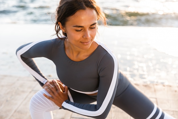 Young fitness lady stretching