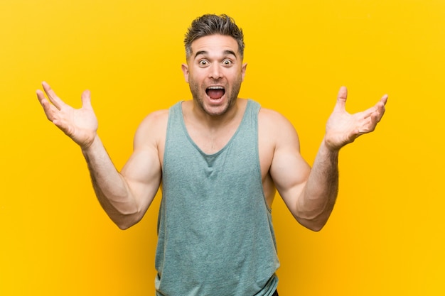 Young fitness man celebrating a victory or success, he is surprised and shocked