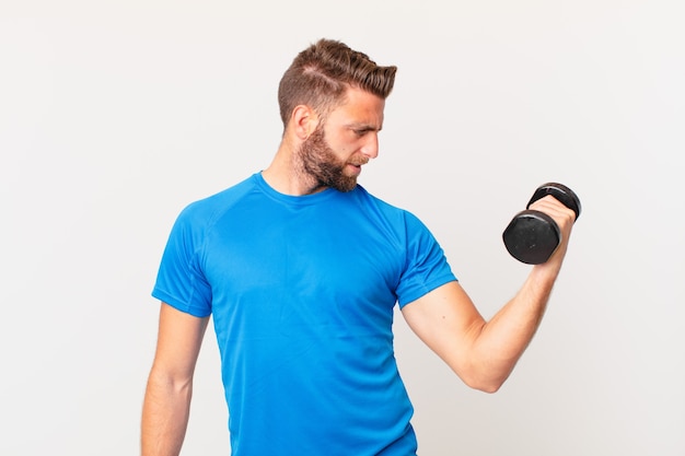 Young fitness man lifting a dumbbell