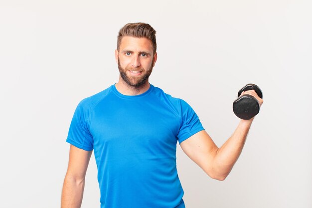 Young fitness man lifting a dumbbell